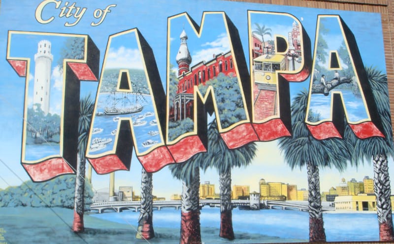 Mural in style of vintage postcard with each letter of word Tampa having different images.