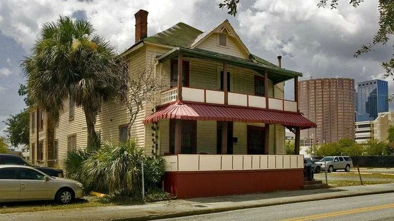 Jackson House in Tampa Fl. The front of a two story wood frame building. Both floors have covered porches.