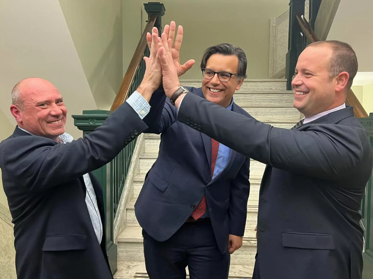 Three men High-fiving.