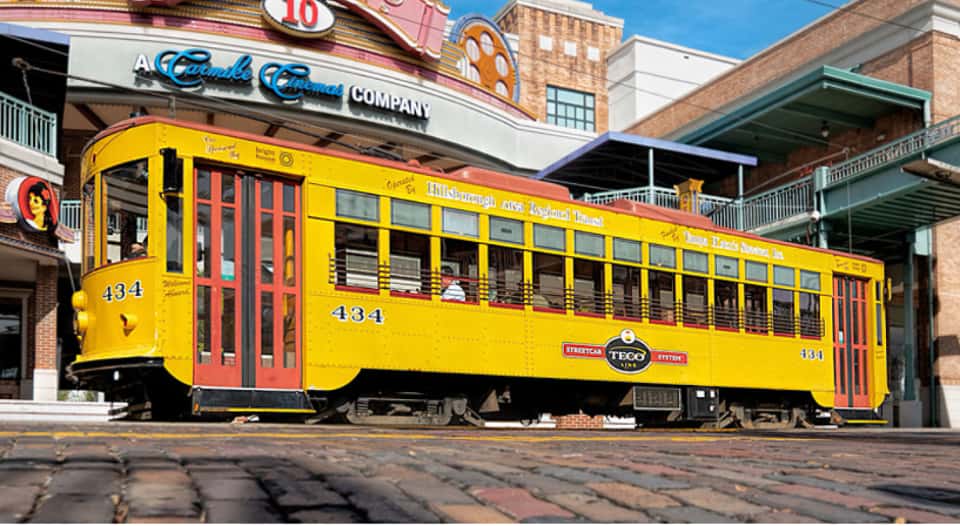 Classic yellow Tampa street car in front of Centro Ybor.